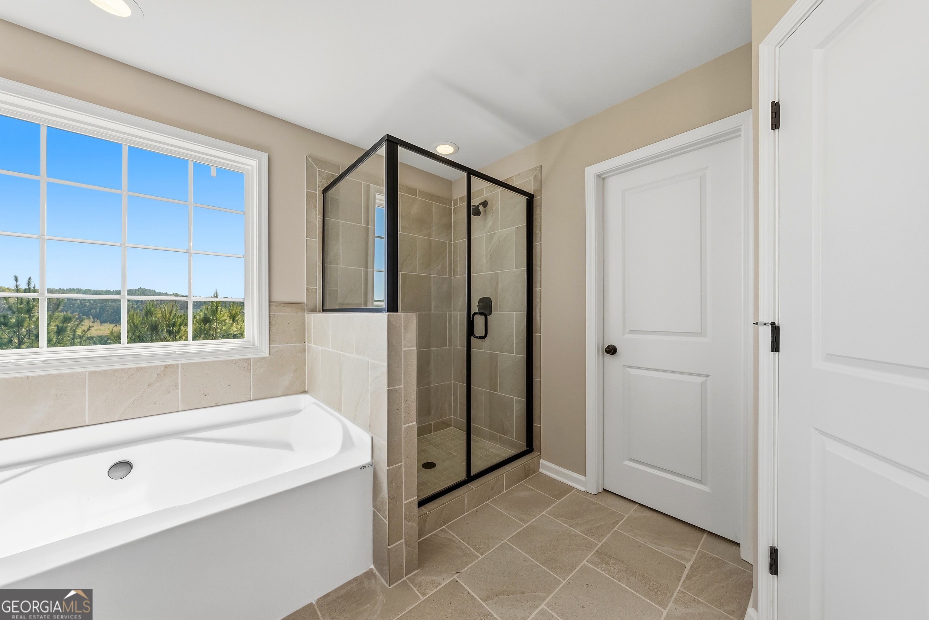 98 Hawkeye Trail, Unit 84 Fortson, GA 31808 - Photo 37 of 42 a bathroom with a bathtub and a shower