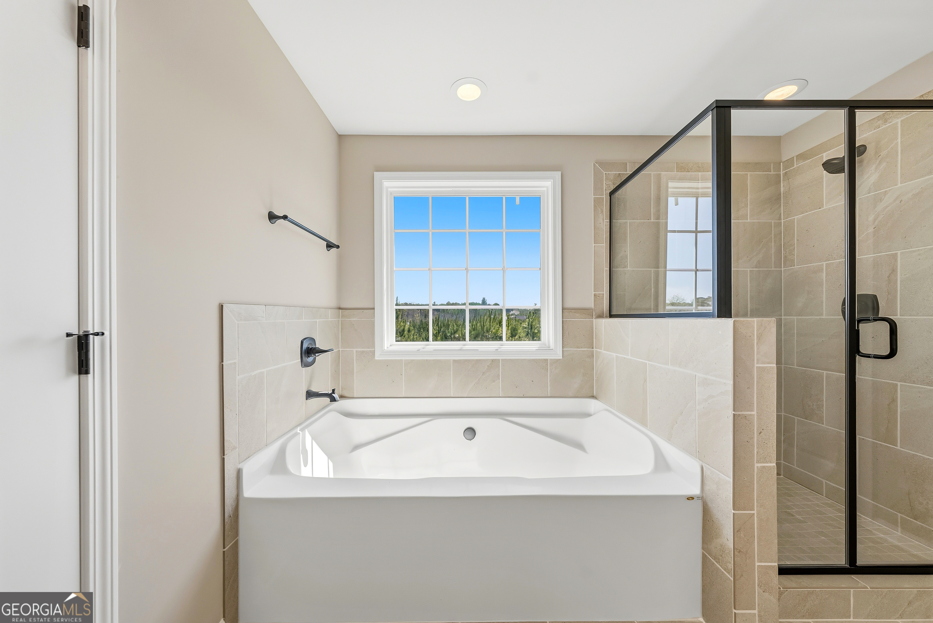 98 Hawkeye Trail, Unit 84 Fortson, GA 31808 - Photo 38 of 42 a bathroom with a bathtub and a shower