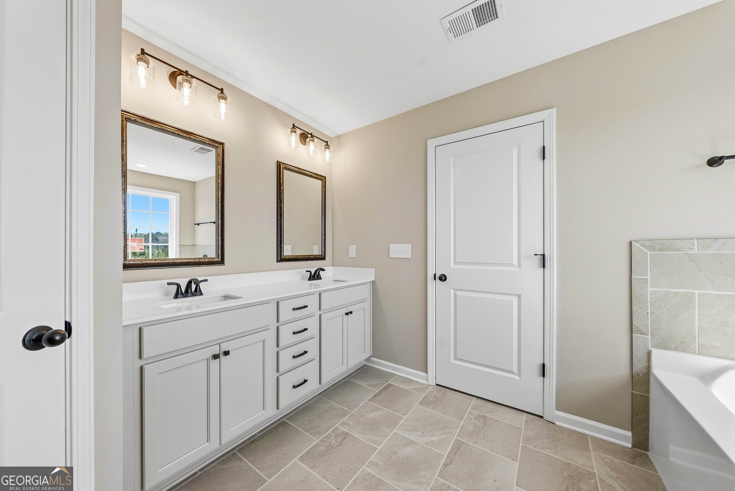 98 Hawkeye Trail, Unit 84 Fortson, GA 31808 - Photo 39 of 42 a spacious bathroom with a double vanity sink mirror and