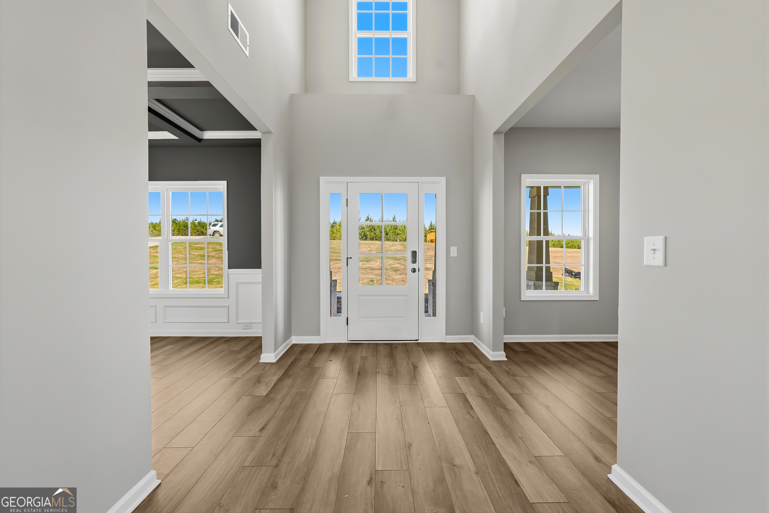 98 Hawkeye Trail, Unit 84 Fortson, GA 31808 - Photo 4 of 42 an empty room with wooden floor and windows