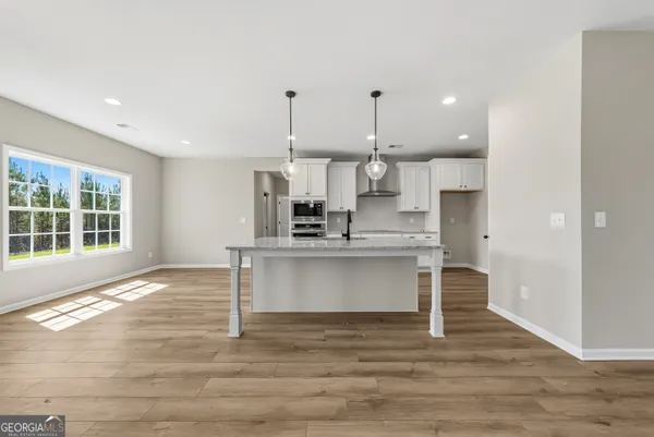 a view of kitchen with wooden floor and window