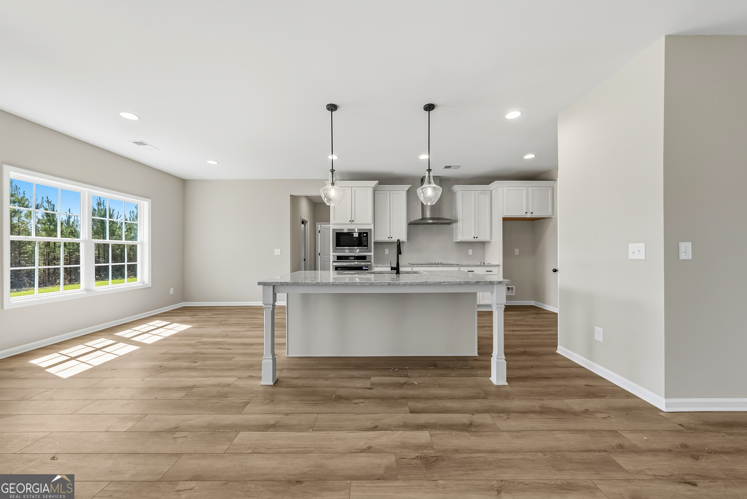 98 Hawkeye Trail, Unit 84 Fortson, GA 31808 - Photo 10 of 42 a view of kitchen with wooden floor and window