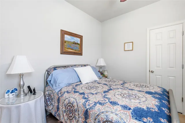 a bedroom with a bed and a lamp