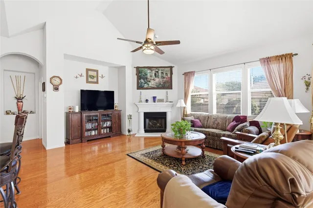 a living room with furniture a fireplace and a flat screen tv
