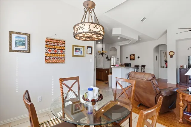 a view of a dining room with furniture wooden floor and a chandelier