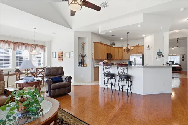 a living room with furniture and kitchen view