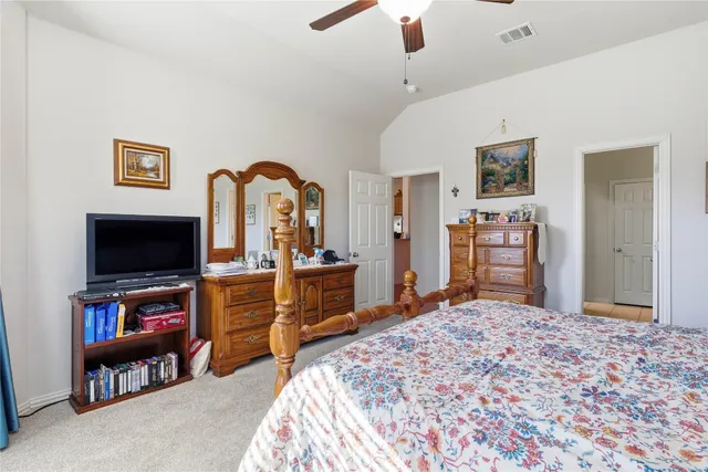 a bedroom with furniture and a flat screen tv