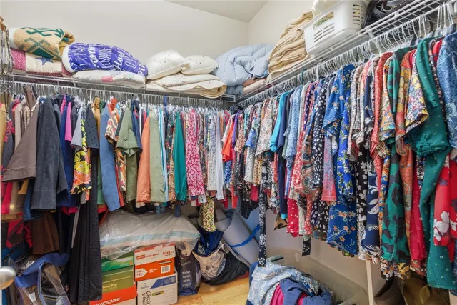 a view of walk in closet with clothes