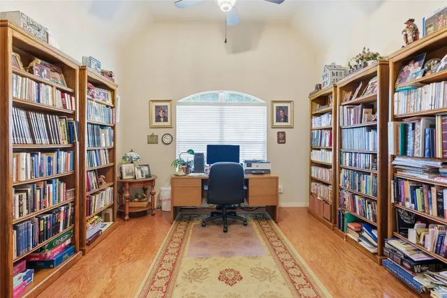 a living room with a book shelf and a book shelf