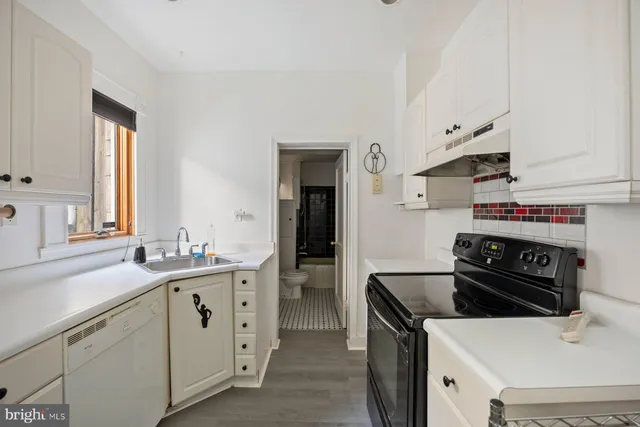 a kitchen with a sink and a stove