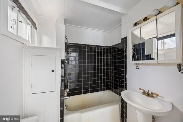 a bathroom with a bathtub and sink