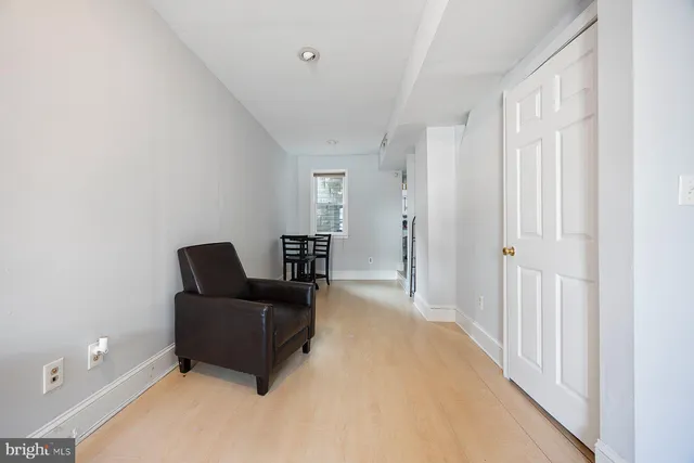 a living room with furniture and a lamp