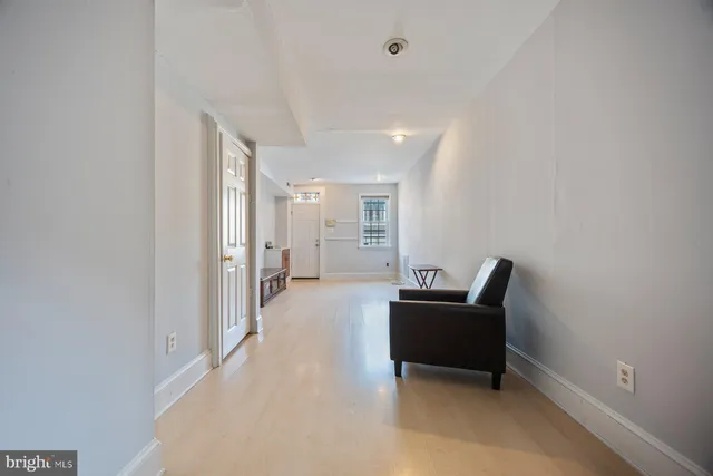 a living room with furniture and a piano