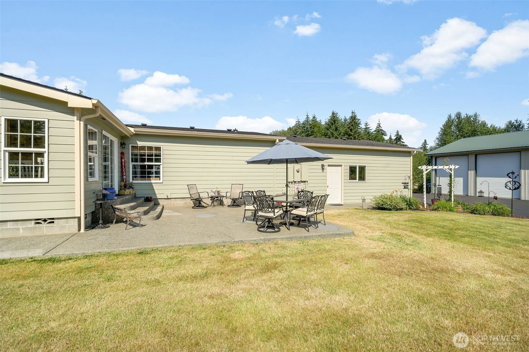 109 Bowers Road Chehalis, WA 98532 - Photo 8 of 38 a view of a patio with table and chairs under an umbrella