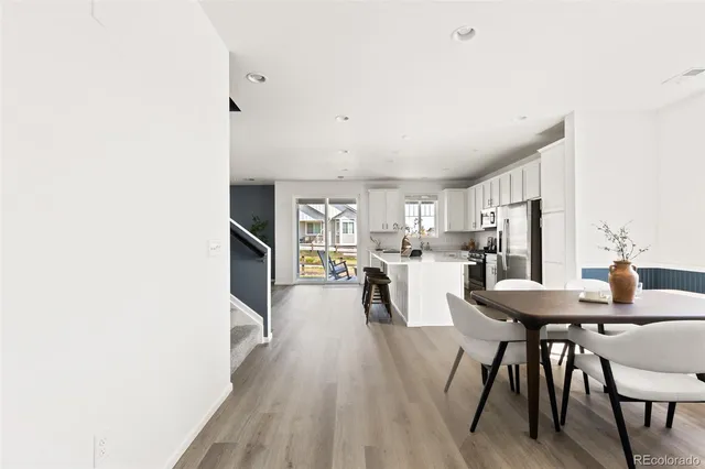 a view of a dining room with furniture and wooden floor