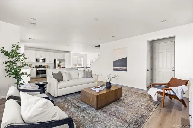 a living room with furniture a rug and a window