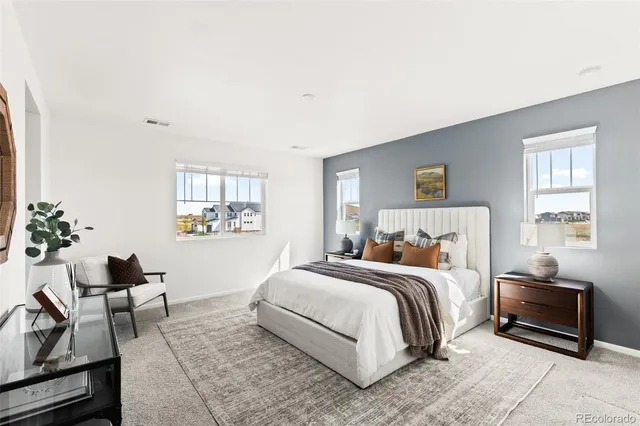 a bedroom with a bed and chair