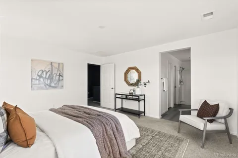 a bedroom with a bed and chair