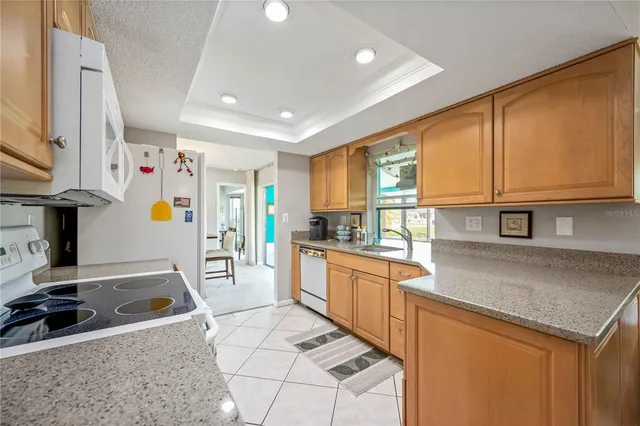 a kitchen with stainless steel appliances granite countertop a sink and a stove