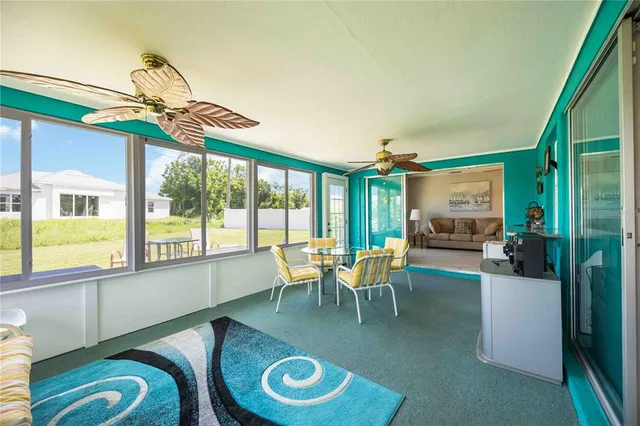 a dining room with furniture water view and a floor to ceiling window