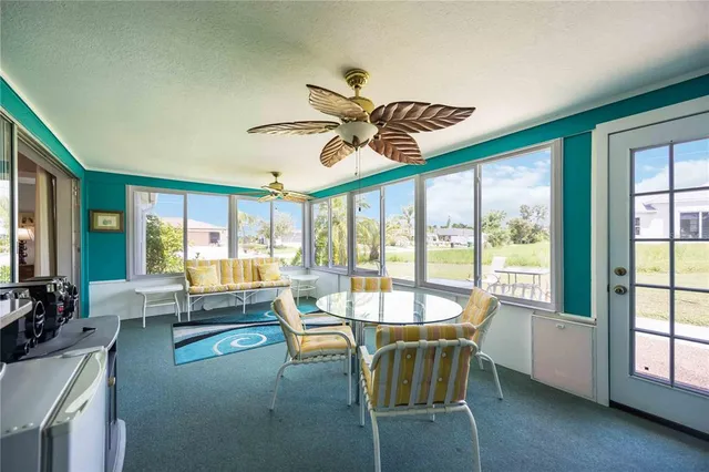a dining room with furniture water view and a floor to ceiling window