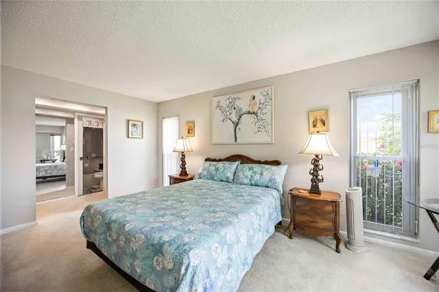 a bedroom with a large bed and a window