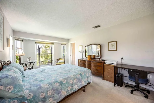 a bedroom with a large bed and a desk