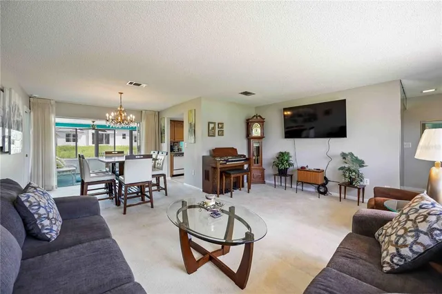 a living room with furniture and a flat screen tv with wooden floor