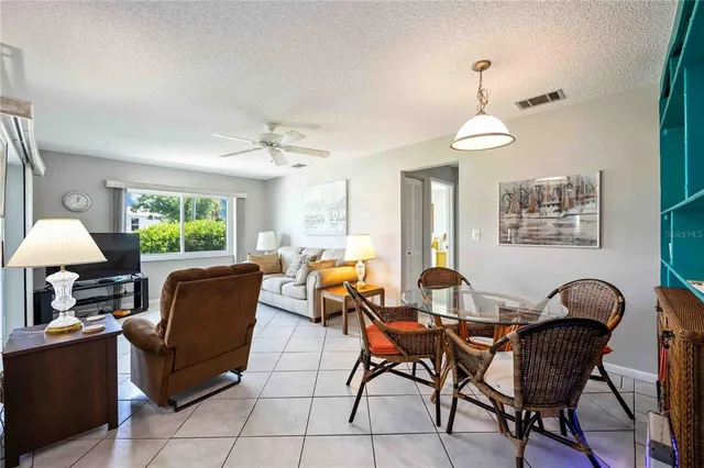 a dining room with furniture a window and a chandelier