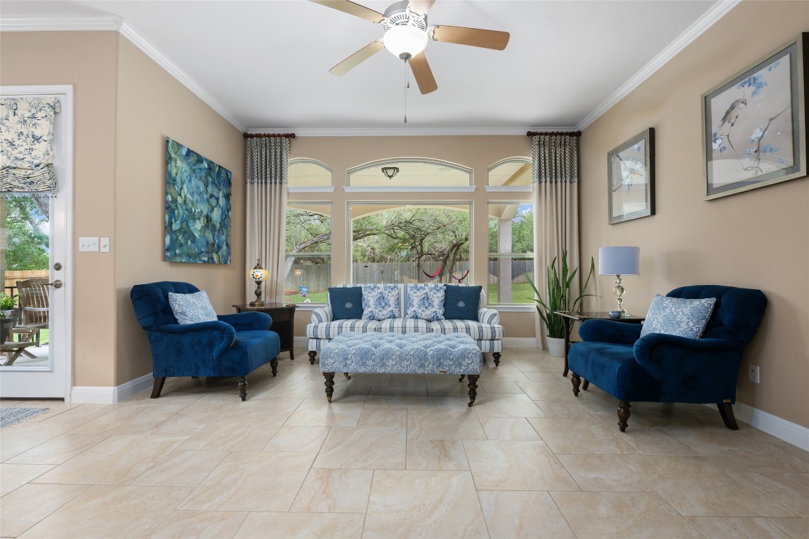 399 Whispering Wind Way Austin, TX 78737 - Photo 14 of 40 Sitting room with ceiling fan, healthy amount of natural light, and ornamental molding