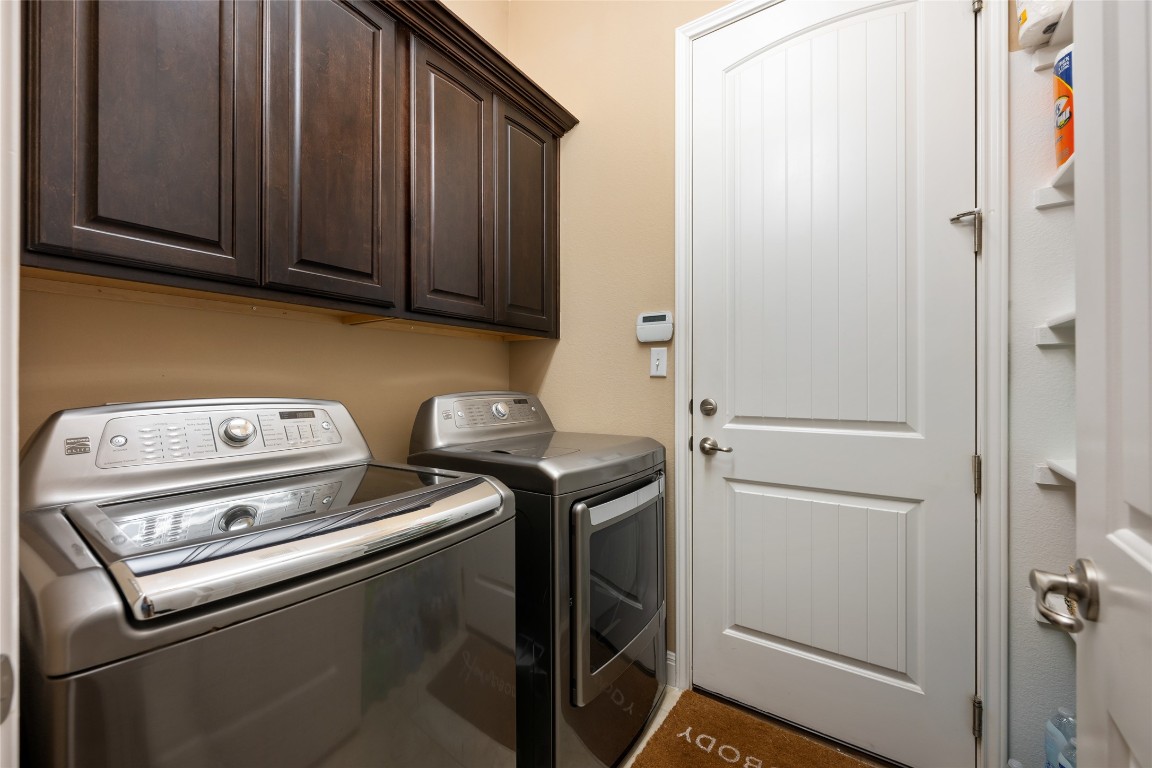 399 Whispering Wind Way Austin, TX 78737 - Photo 29 of 40 Washroom with separate washer and dryer and cabinet space