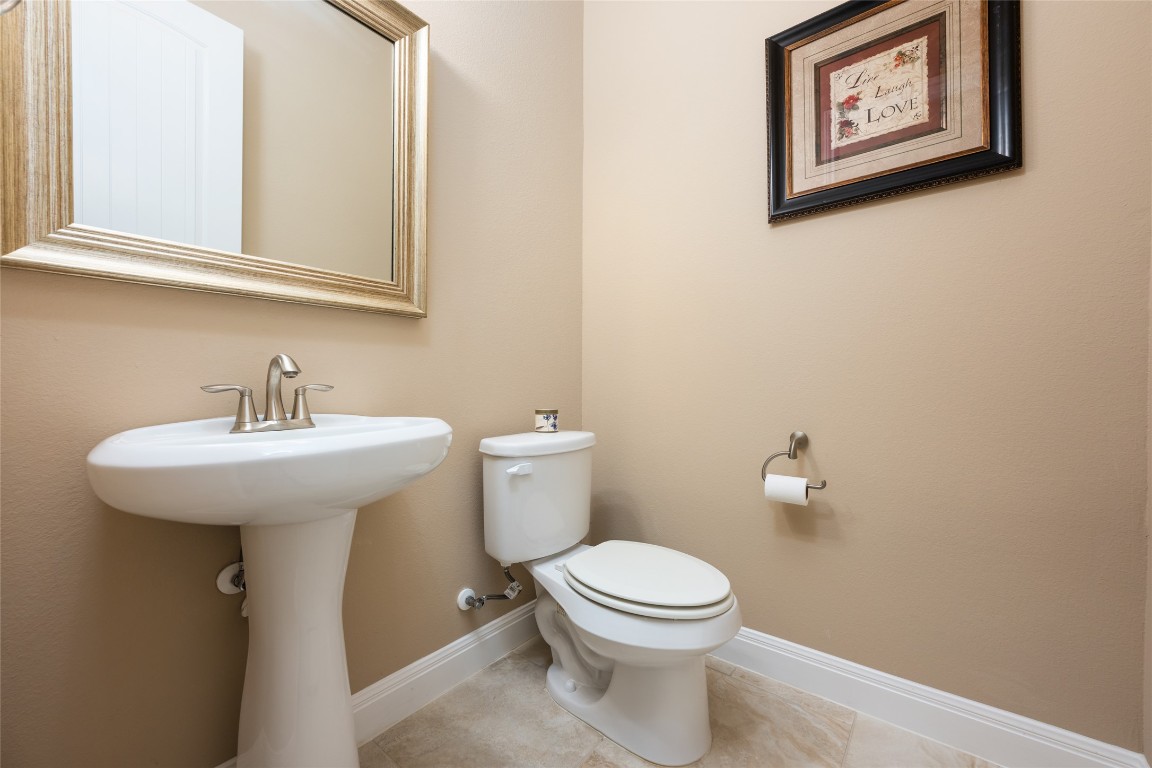 399 Whispering Wind Way Austin, TX 78737 - Photo 30 of 40 Half bathroom featuring toilet and tile patterned floors