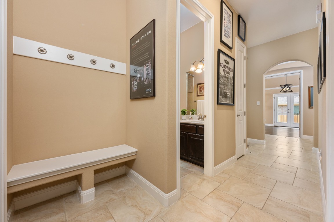 399 Whispering Wind Way Austin, TX 78737 - Photo 7 of 40 Mudroom with arched walkways and light marble finish flooring