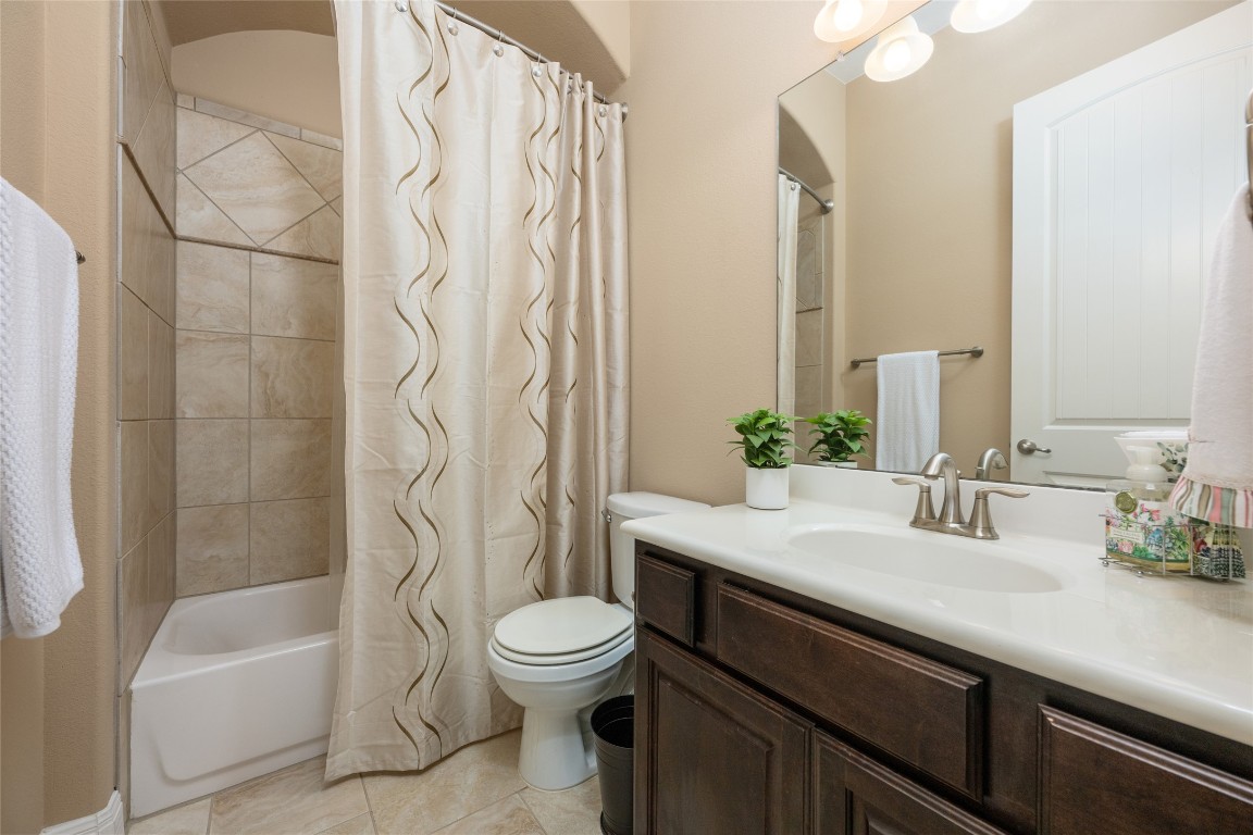 399 Whispering Wind Way Austin, TX 78737 - Photo 8 of 40 Bathroom featuring vanity, tile patterned flooring, and shower / tub combo