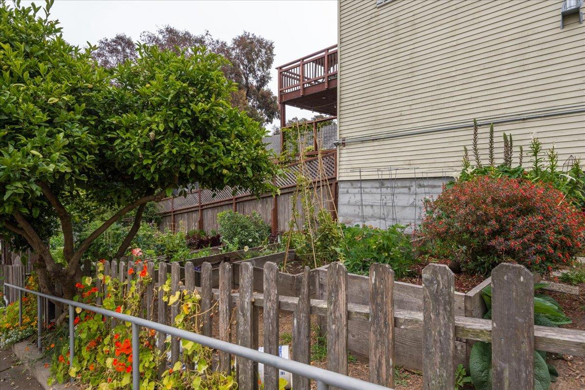 108 Cortland Avenue San Francisco, CA 94110 - Photo 17 of 27 a view of a house with a small yard and wooden fence