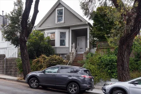 a view of a car parked in front of a house