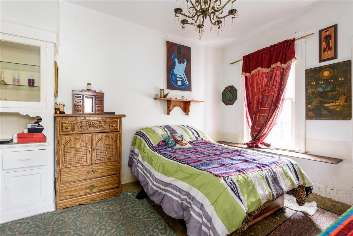 108 Cortland Avenue San Francisco, CA 94110 - Photo 7 of 27 a bedroom with a bed and a dresser in it