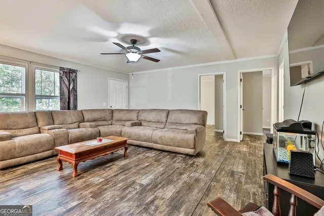 a living room with furniture a flat screen tv and a fireplace