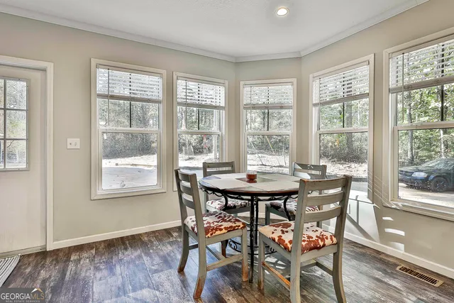 a view of a dining room with furniture and wooden floor