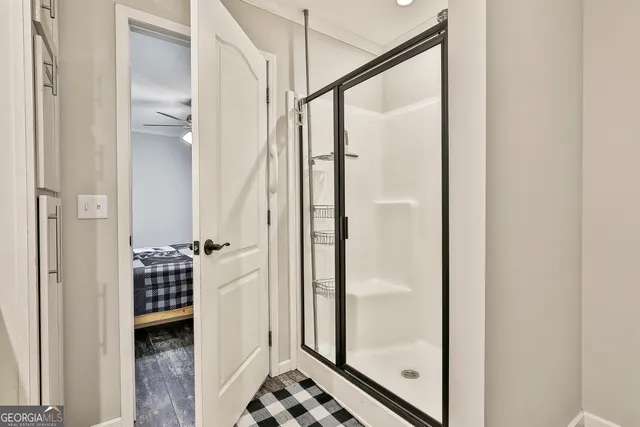 a bathroom with a glass shower door and a bathroom