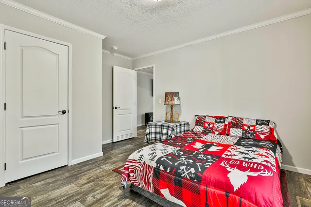 a bedroom with a bed and a potted plant