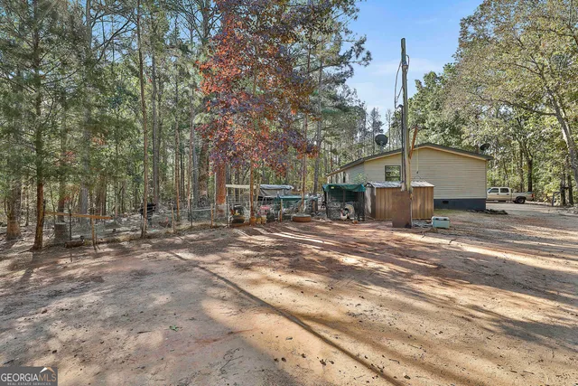 a backyard of house with large trees