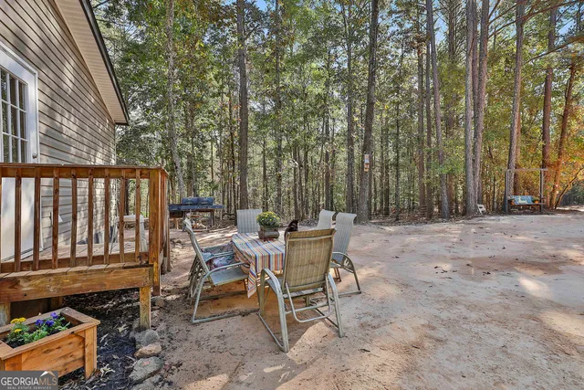 a view of a chairs and tables in the back yard