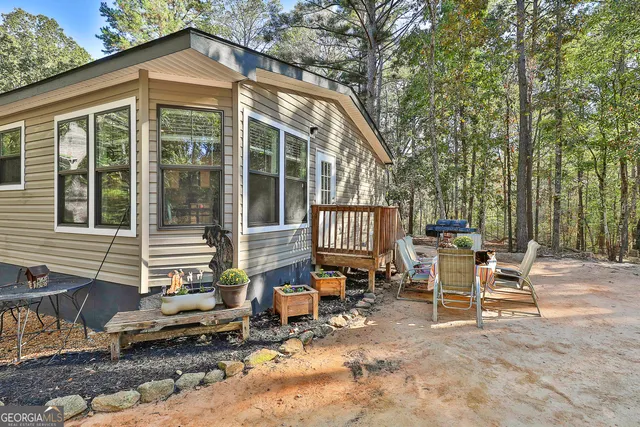 a view of a chair and tables in the back yard of the house
