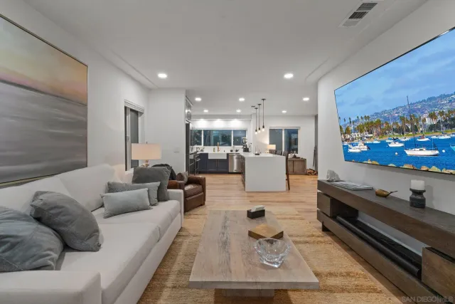 a bedroom with a bed and dresser with mirror