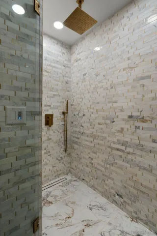 a bathroom with a shower and a sink
