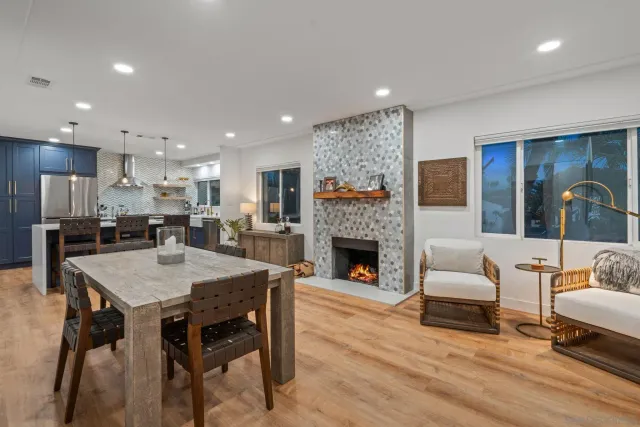 a living room with furniture a fireplace and kitchen view