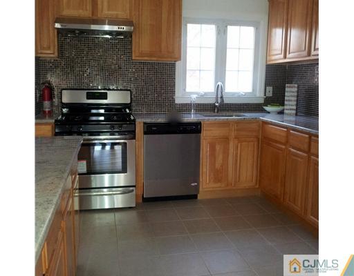 3 Monaghan Road Edison, NJ 08817 - Photo 2 of 16 a kitchen with stainless steel appliances granite countertop a stove a sink and a microwave