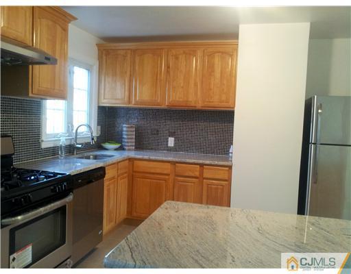 3 Monaghan Road Edison, NJ 08817 - Photo 12 of 16 a kitchen with stainless steel appliances granite countertop a sink stove and refrigerator