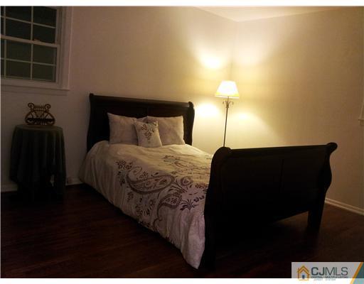3 Monaghan Road Edison, NJ 08817 - Photo 5 of 16 a bedroom with a bed and a lamp on the table
